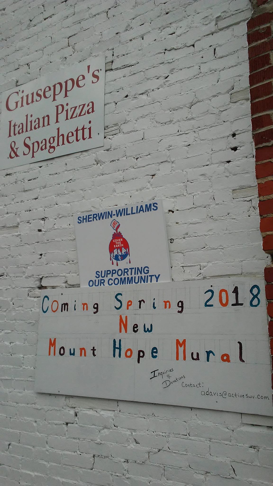 Coming Soon mural announcement signage at Giuseppe's Pizza building